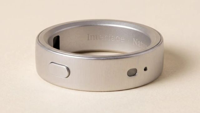 Silver Interface ring with an oval button, a mesh opening and a dark sensor on its inner band