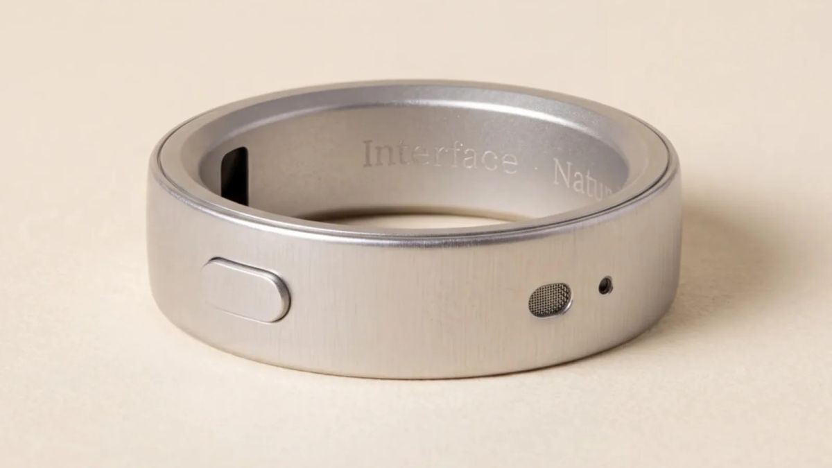 Silver Interface ring with an oval button, a mesh opening and a dark sensor on its inner band